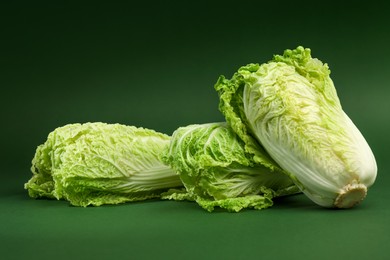 Photo of Fresh ripe Chinese cabbages on green background