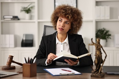 Notary with notebook at workplace in office