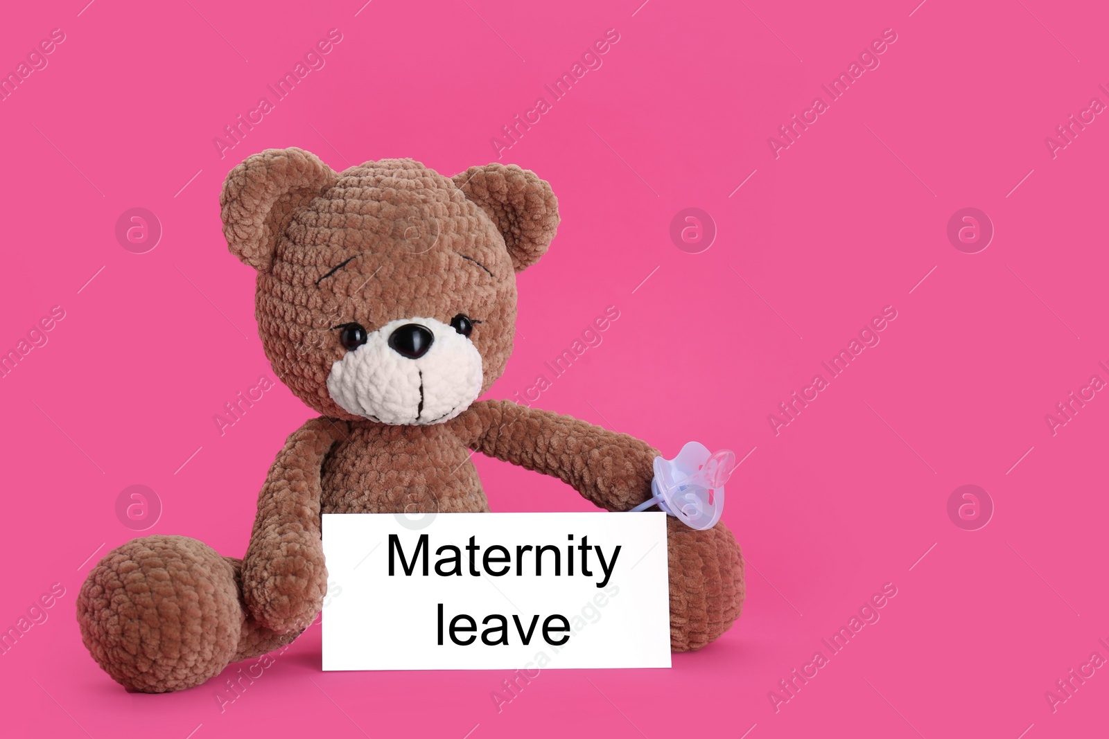 Photo of Toy bear, baby pacifier and note with words Maternity Leave on pink background. Space for text