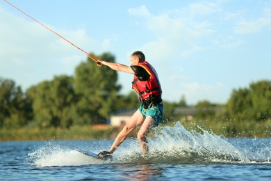 Man wakeboarding on river. Extreme water sport