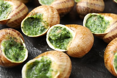 Delicious cooked snails on table, closeup view