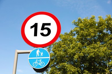 Image of Road signs Maximum speed limit and Shared cycle and pedestrian path outdoors