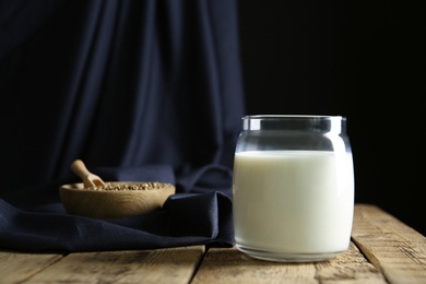 Photo of Jar of hemp milk on wooden table