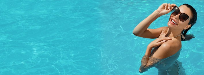 Image of Beautiful woman wearing bikini in swimming pool, space for text. Banner design