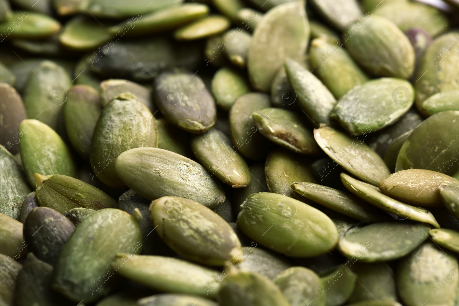 Photo of Shelled raw pumpkin seeds as background, closeup