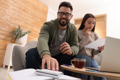 Young couple discussing family budget at home