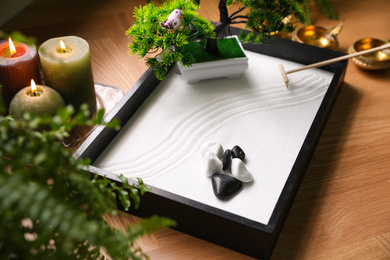 Photo of Beautiful miniature zen garden and candles on table