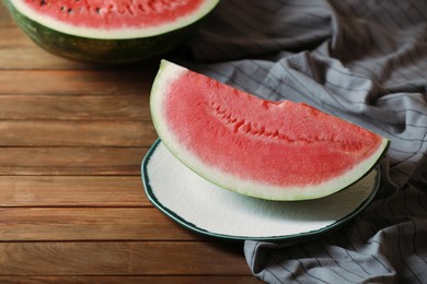 Photo of Sliced fresh juicy watermelon on wooden table. Space for text
