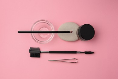 Photo of Eyebrow henna and professional tools on pink background, flat lay