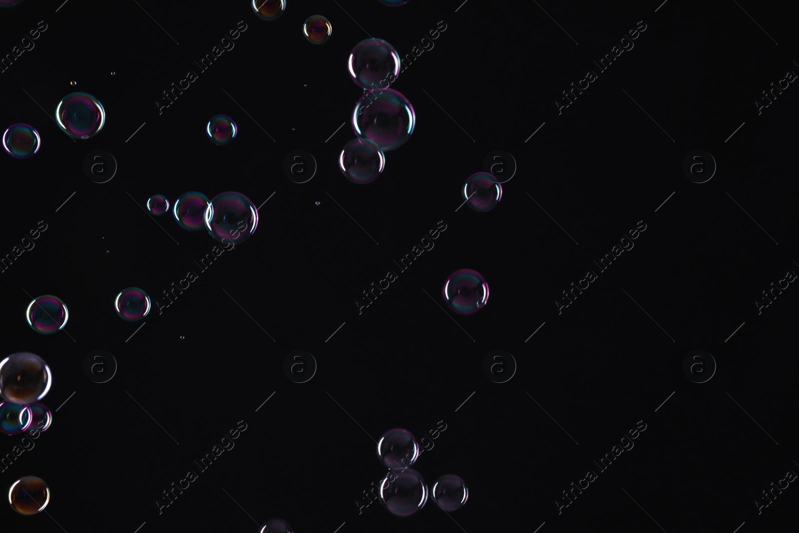 Photo of Many beautiful soap bubbles on black background. Space for text