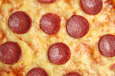 Photo of Tasty pepperoni pizza as background, top view