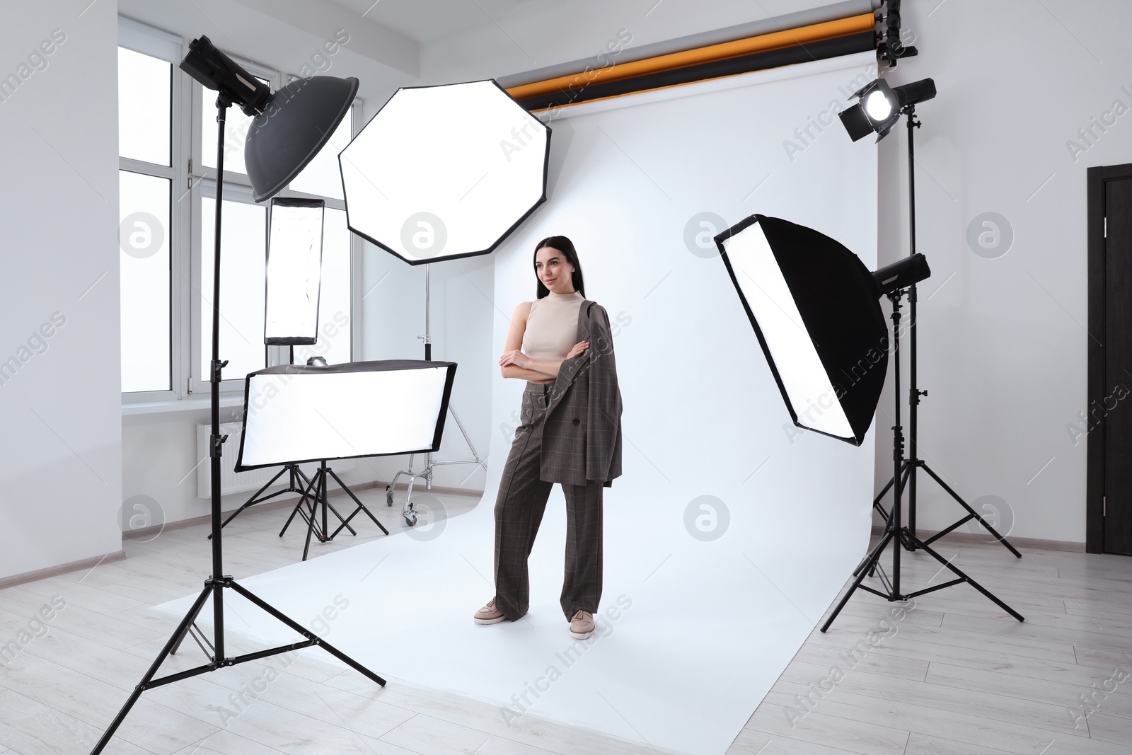 Photo of Beautiful young model posing in modern studio. Professional photo session