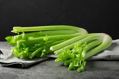 Photo of Fresh green celery bunches on grey table