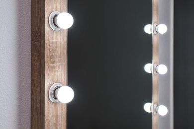 Photo of Beautiful mirror in modern makeup room, closeup