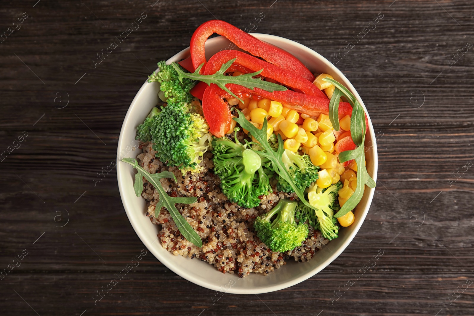 Photo of Bowl with quinoa and different vegetables on table, top view