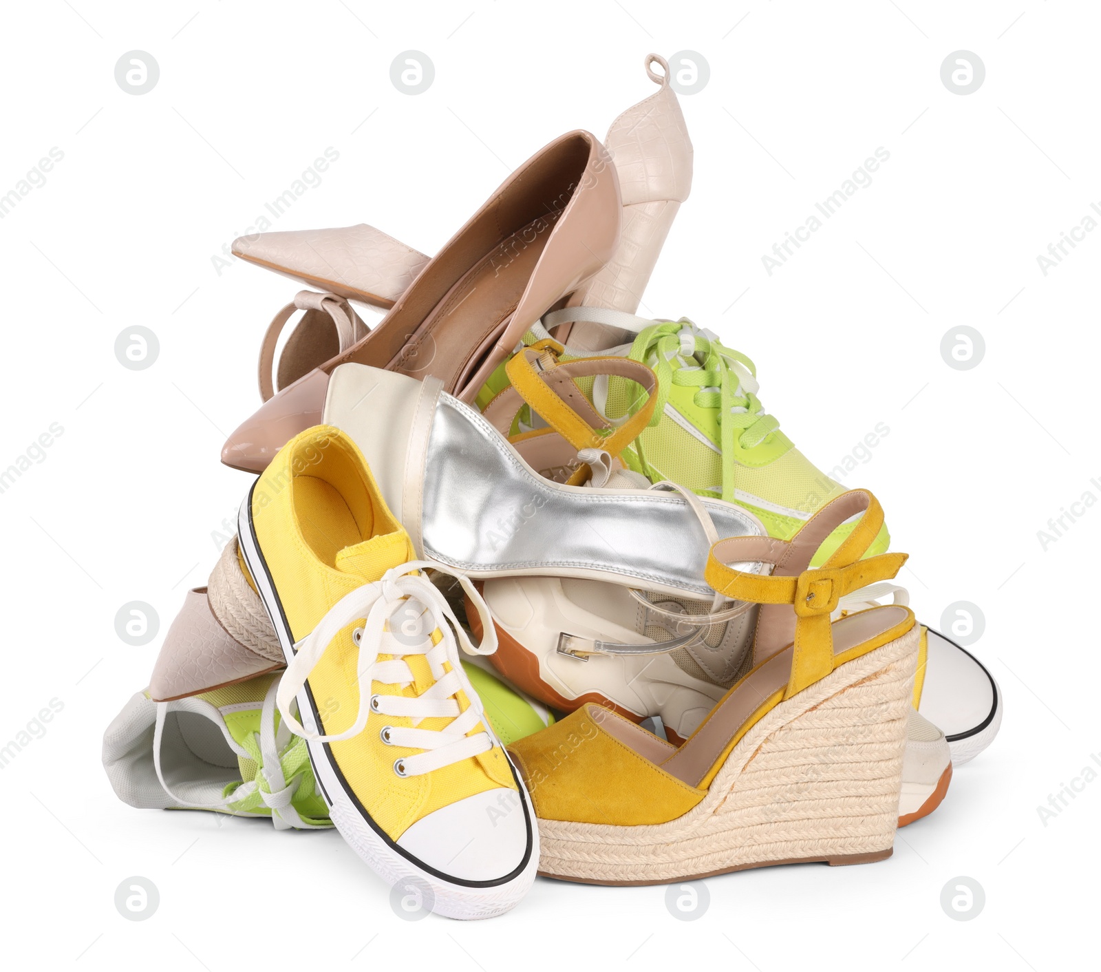 Photo of Pile of different female shoes isolated on white