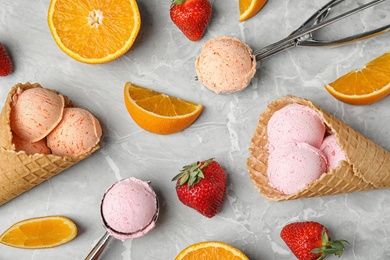 Flat lay composition with delicious ice creams in waffle cones on table