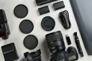 Photo of Flat lay composition with equipment for professional photographer on grey marble table