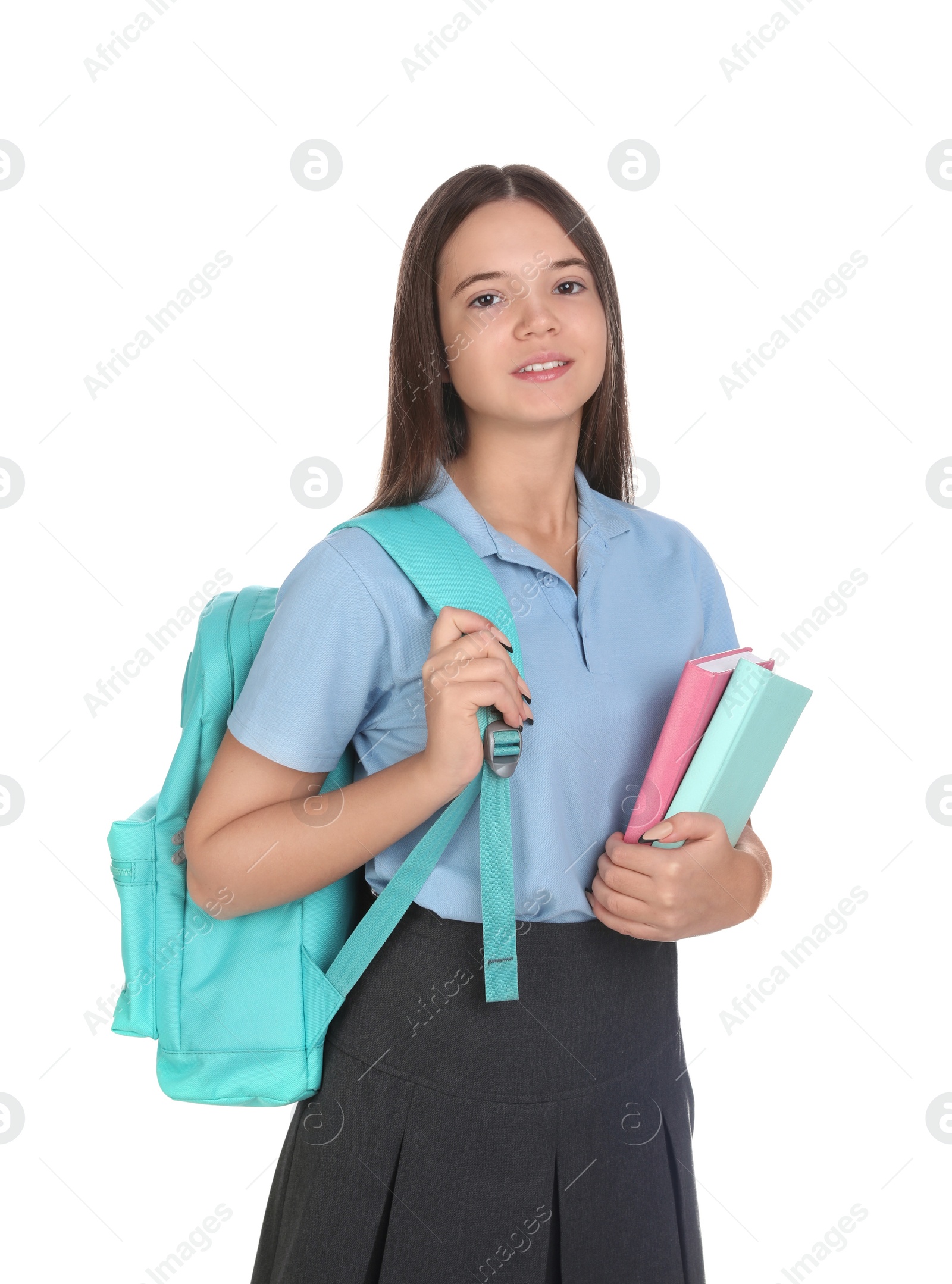 Photo of Teenage girl in school uniform with books and backpack on white background