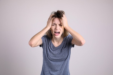 Photo of Portrait of stressed young woman on light background