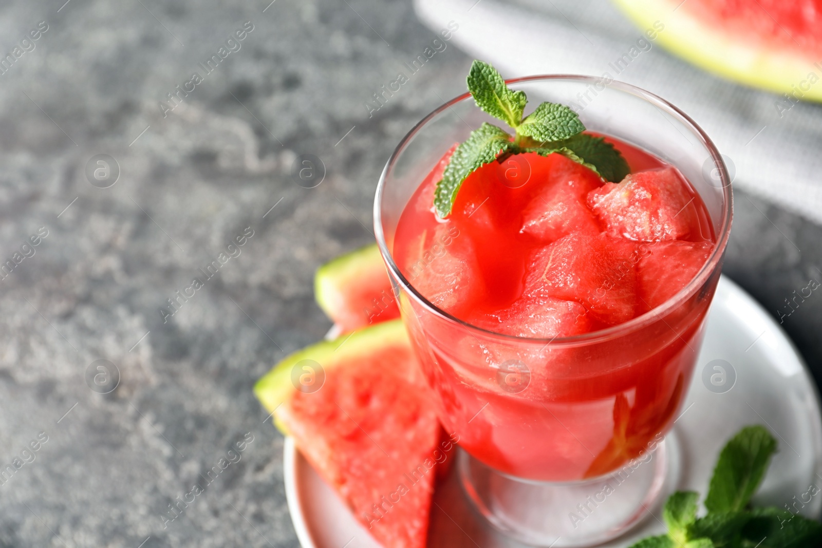 Photo of Tasty summer watermelon drink with mint on table, closeup