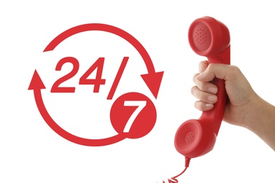 Image of 24/7 hotline service. Woman holding handset on white background, closeup