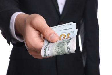 Photo of Money exchange. Man holding dollar banknotes on white background, closeup