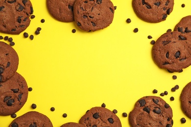 Photo of Delicious chocolate chip cookies on color background, flat lay. Space for text