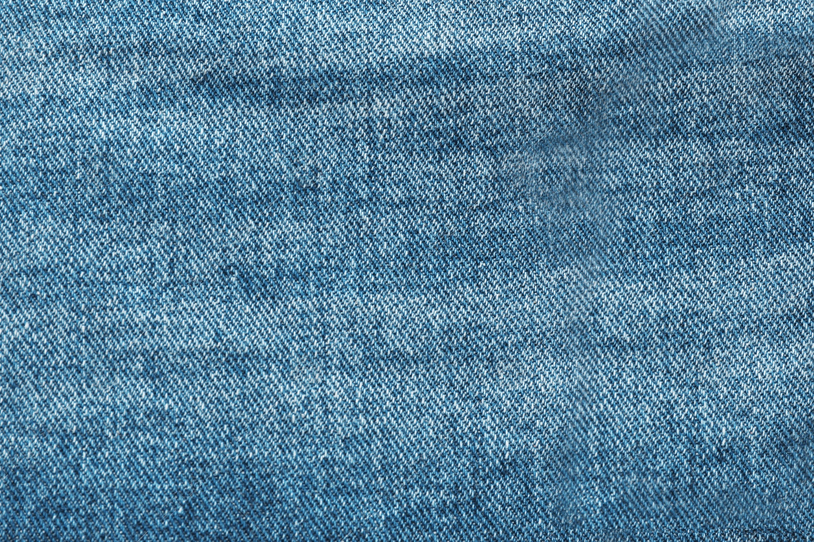 Photo of Texture of blue jeans as background