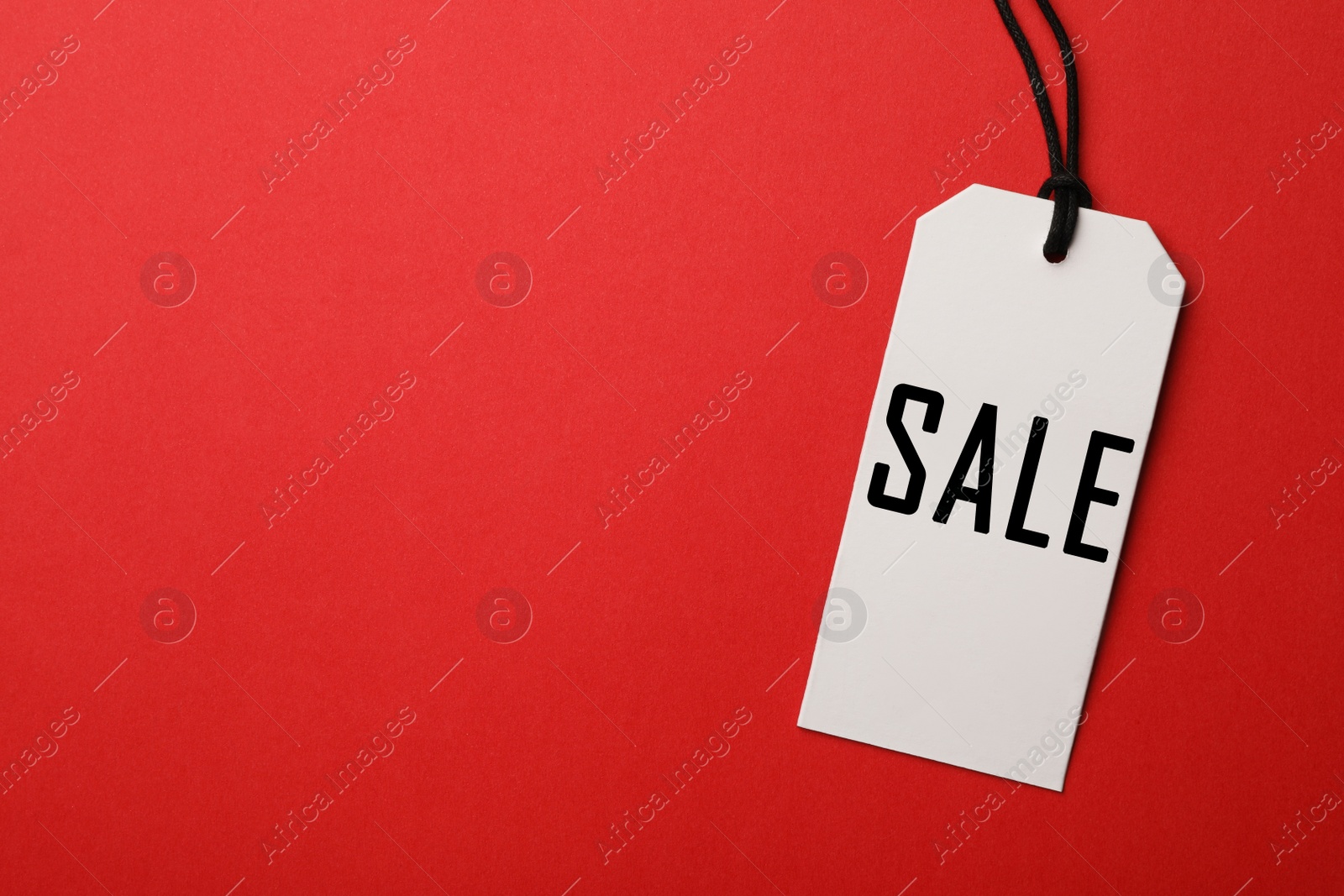 Image of Top view of tag with inscription SALE on red background, space for text. Black Friday 