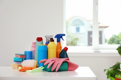 Photo of Set of cleaning supplies on table indoors