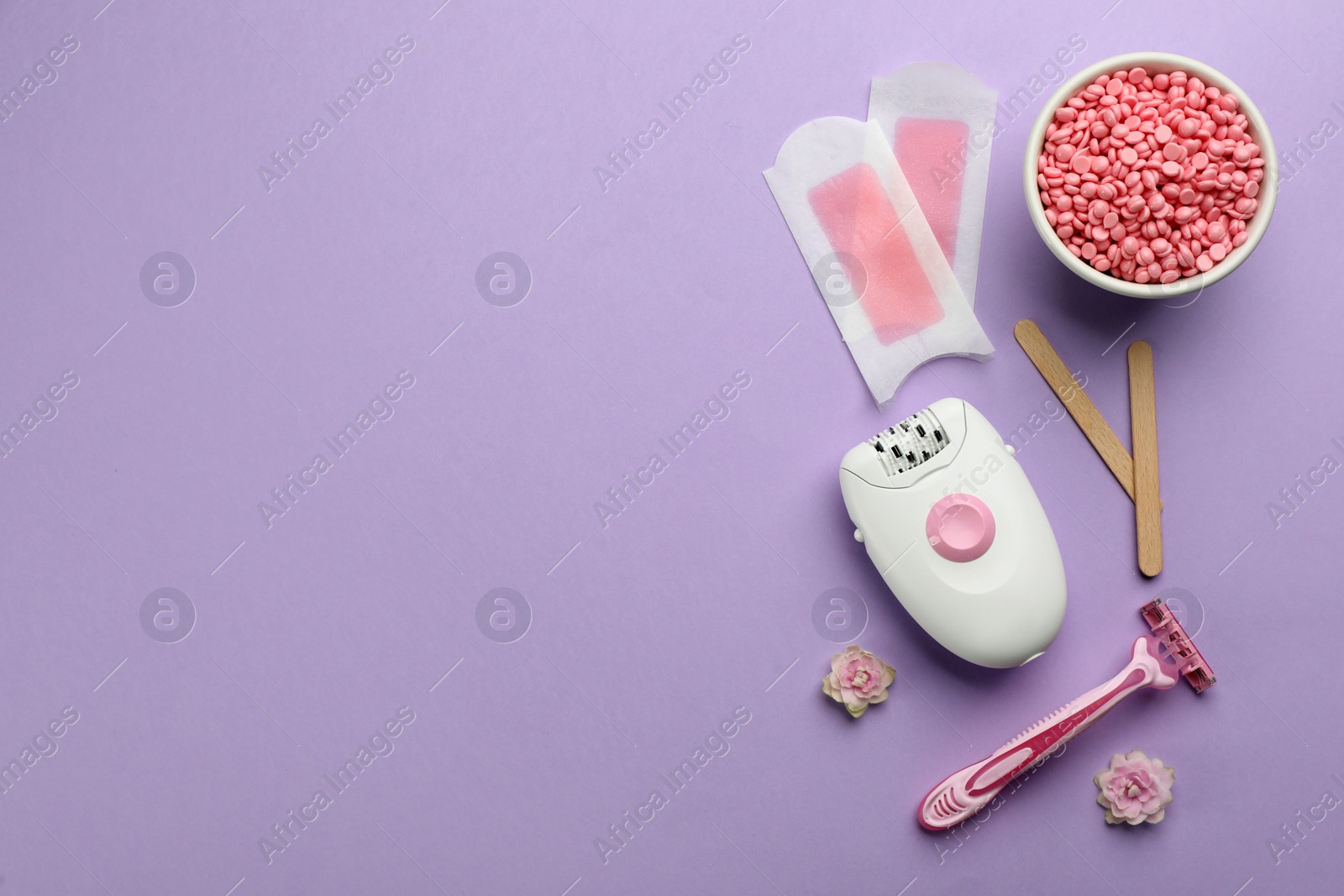 Photo of Set of epilation products on lilac background, flat lay. Space for text