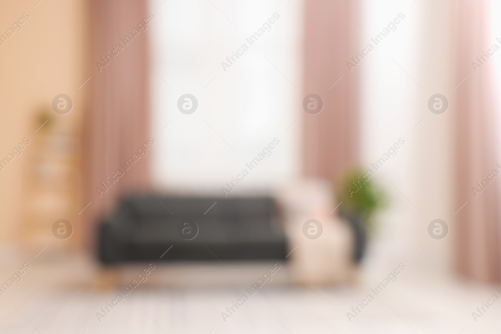 Photo of Blurred view of living room with sofa and curtains