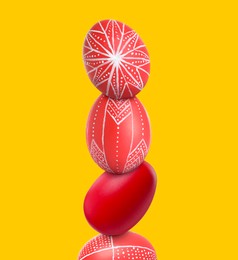 Image of Stack of bright Easter eggs on yellow background
