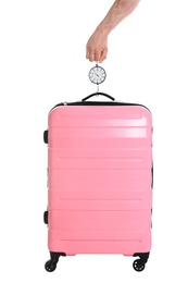 Photo of Man weighing stylish suitcase on white background