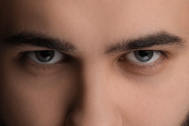 Evil eye. Man with scary eyes, closeup