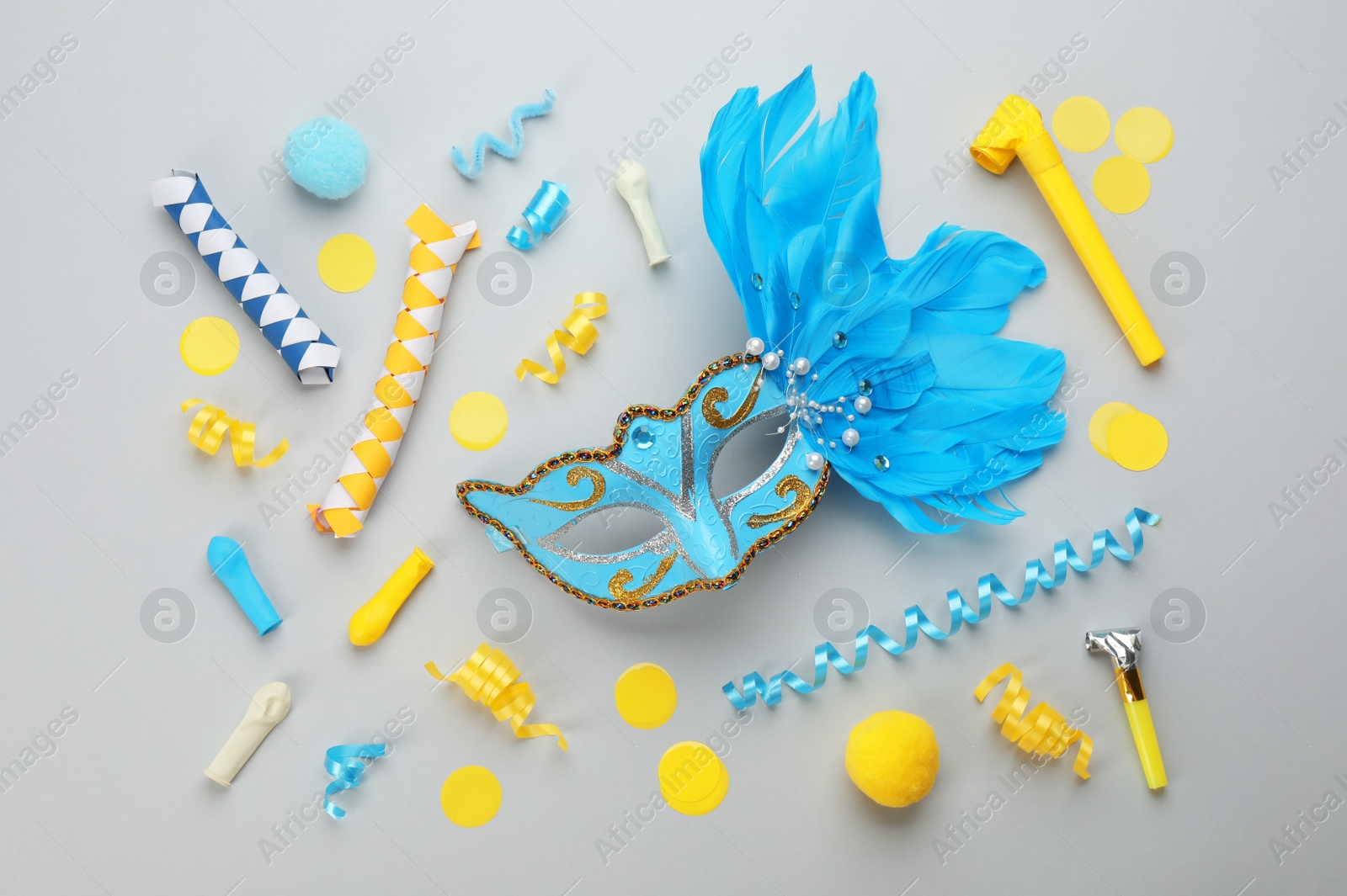 Photo of Flat lay composition with carnival items on light grey background