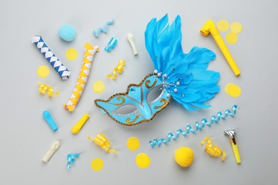 Flat lay composition with carnival items on light grey background