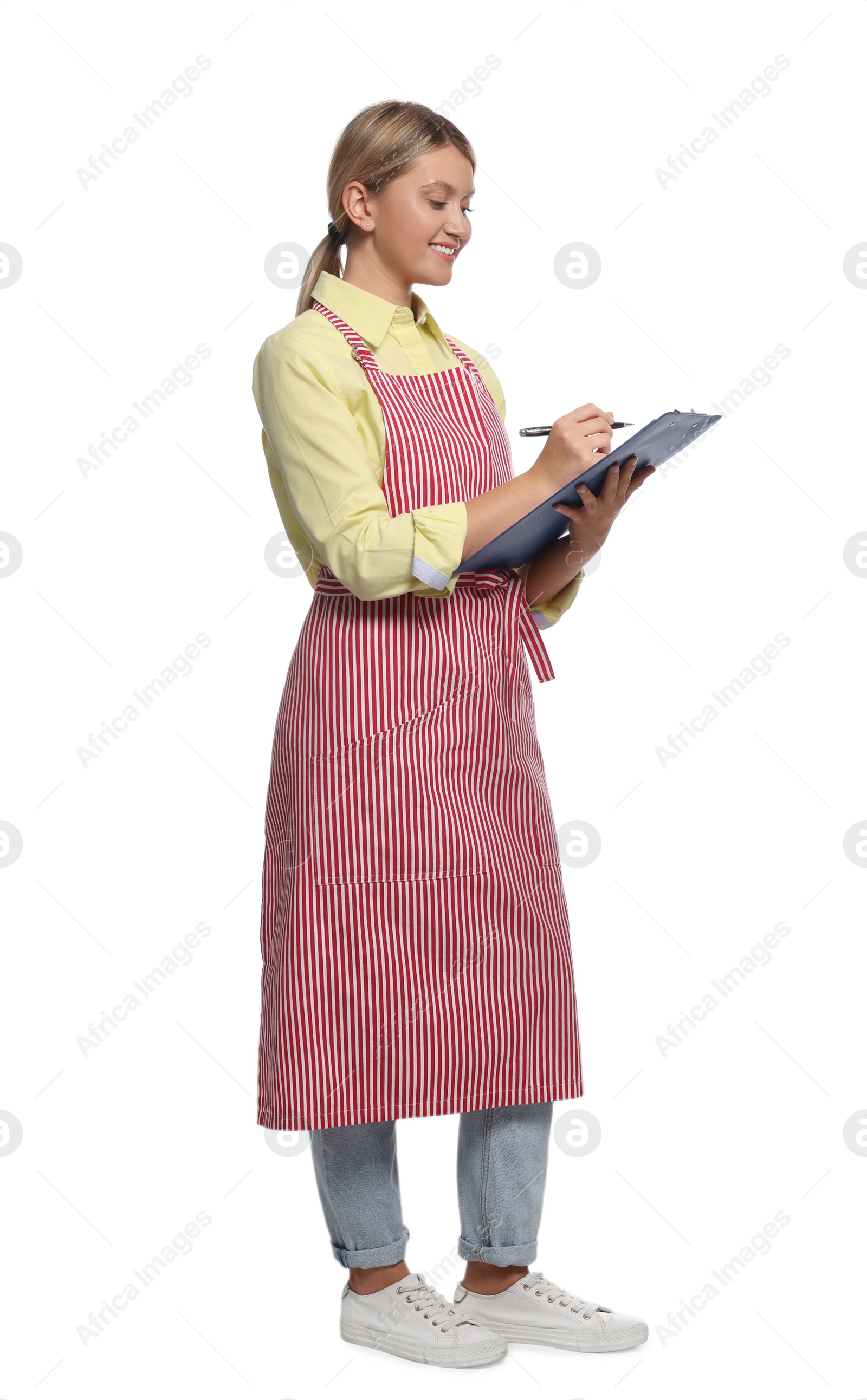 Photo of Beautiful young woman in clean striped apron with clipboard on white background