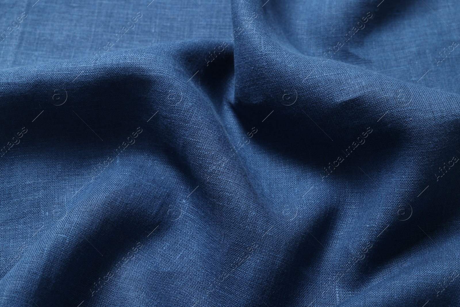 Photo of Texture of blue crumpled fabric as background, closeup