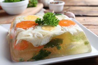 Photo of Delicious fish aspic with parsley on plate, closeup