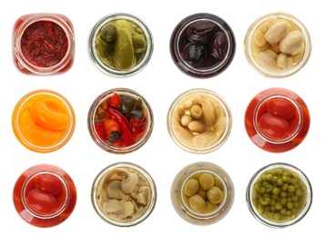 Set of jars with pickled foods on white background, top view