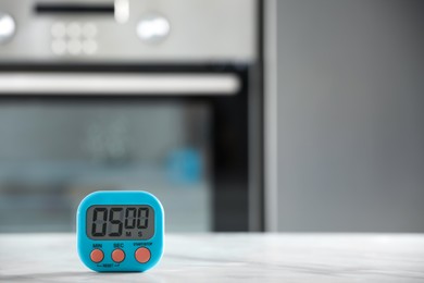 Photo of Kitchen timer on light grey table indoors. Space for text