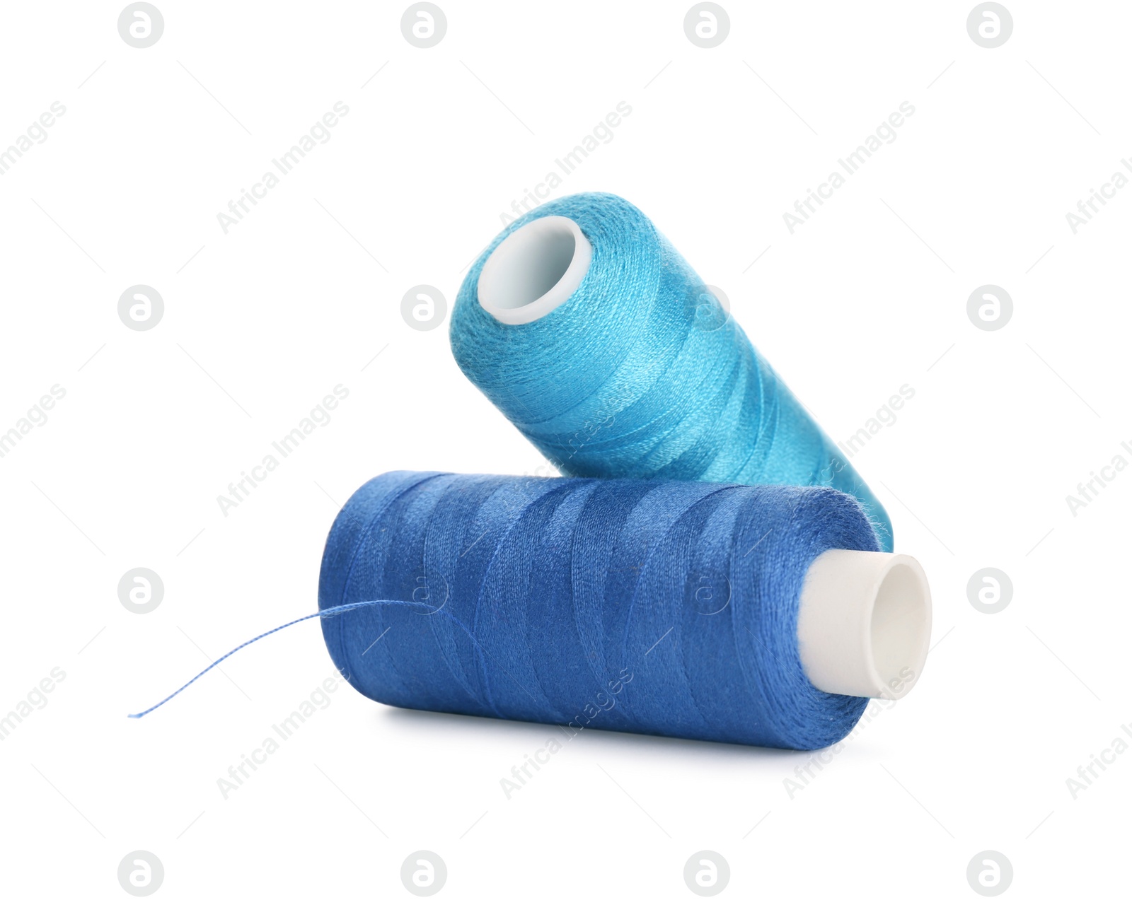 Photo of Different colorful sewing threads on white background