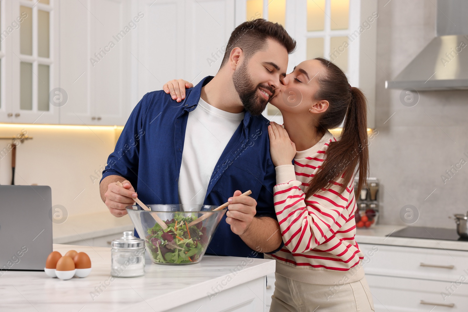 Photo of Happy lovely couple cooking together in kitchen