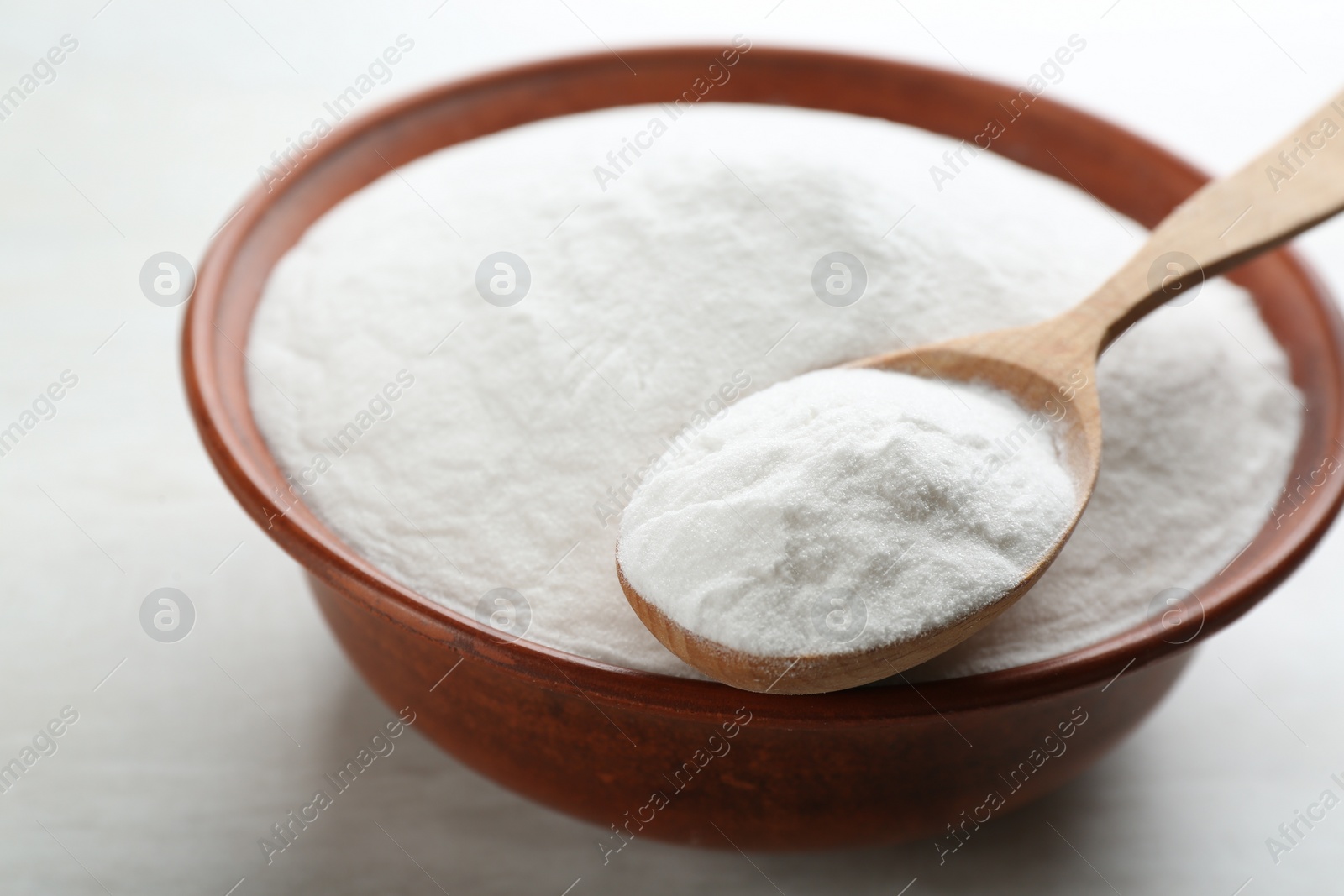 Photo of Baking soda on white wooden table, closeup