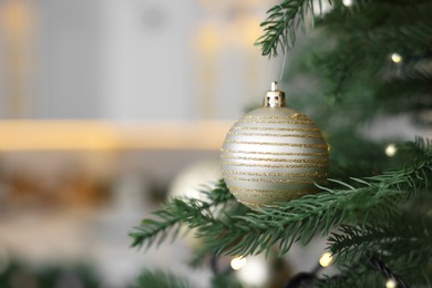 Photo of Closeup view of beautiful decorated Christmas tree in kitchen. Space for text