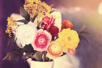 Image of Vase with beautiful ranunculus flowers on blurred background