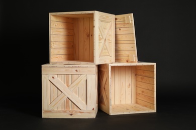 Photo of Group of wooden crates on black background