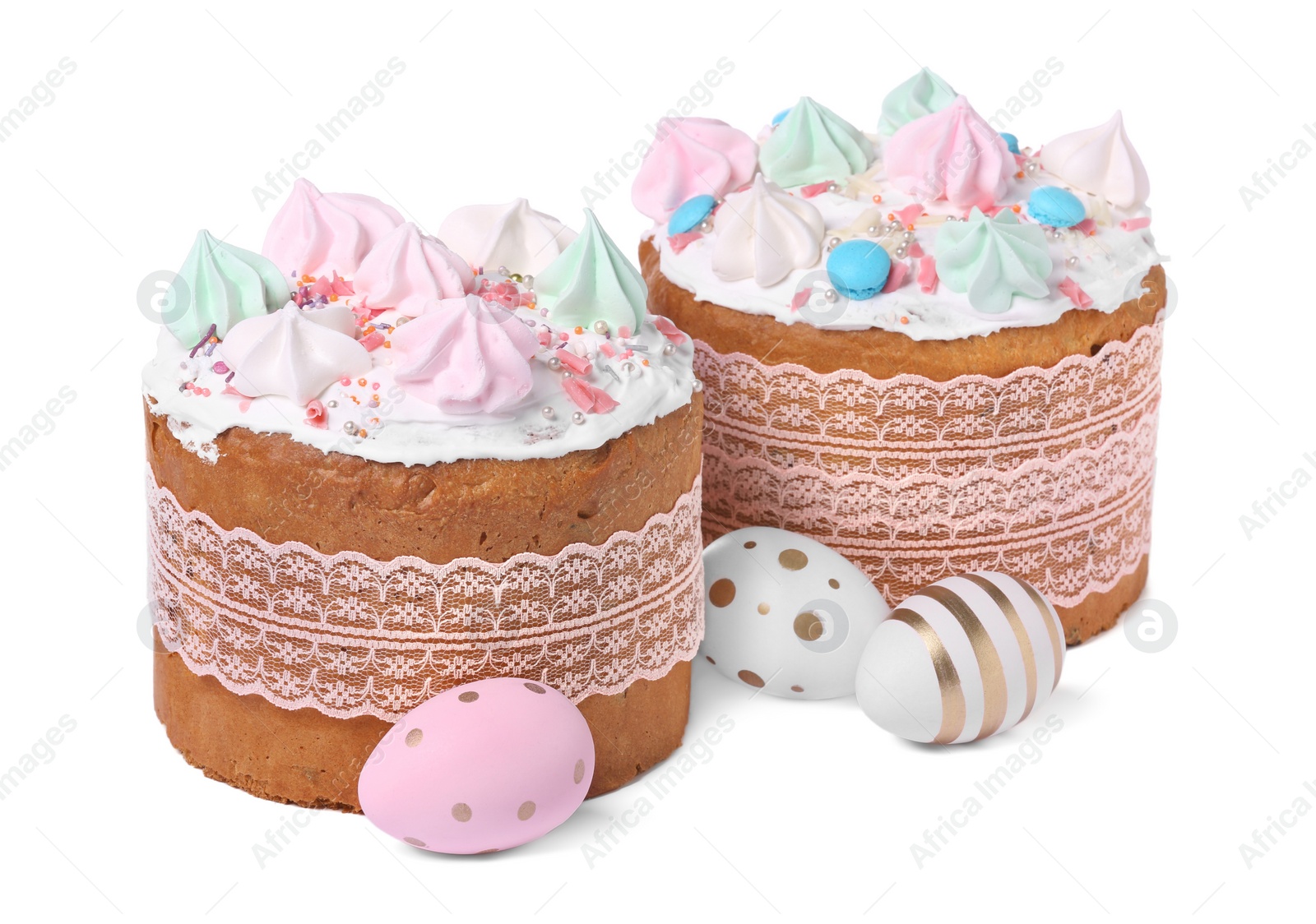 Photo of Traditional Easter cakes with meringues and decorated eggs isolated on white